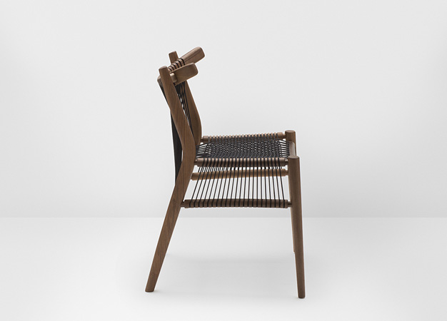 Hayche dining chair with a woven black cord seat and backrest, seen from the side