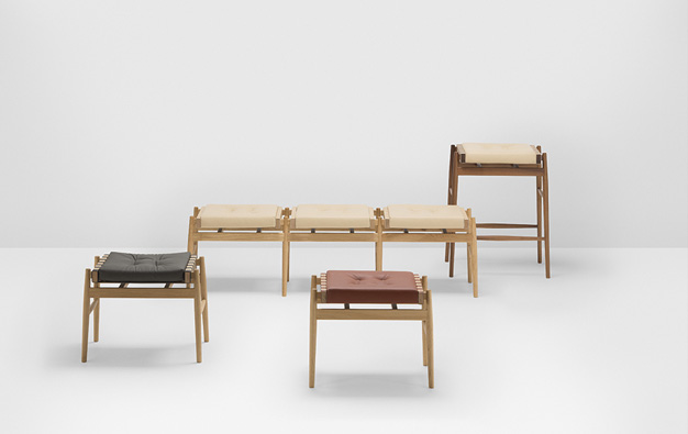 Hayche bench with cream cushions, a barstool, a low stool and a footstool in a studio setting