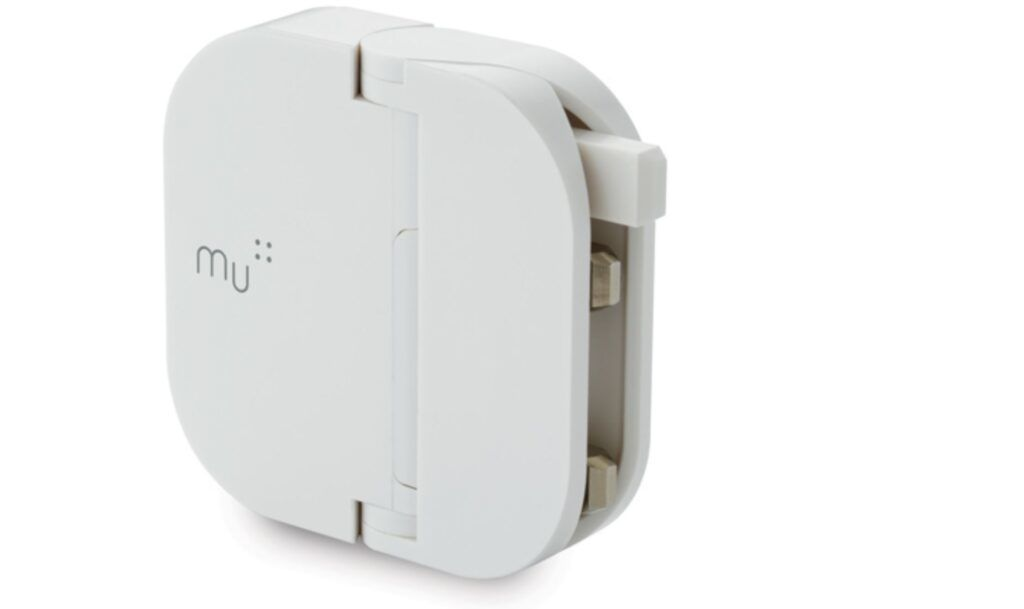 Mu folding plug folded flat and standing at an angle on a white background, with the mu logo printed on its face